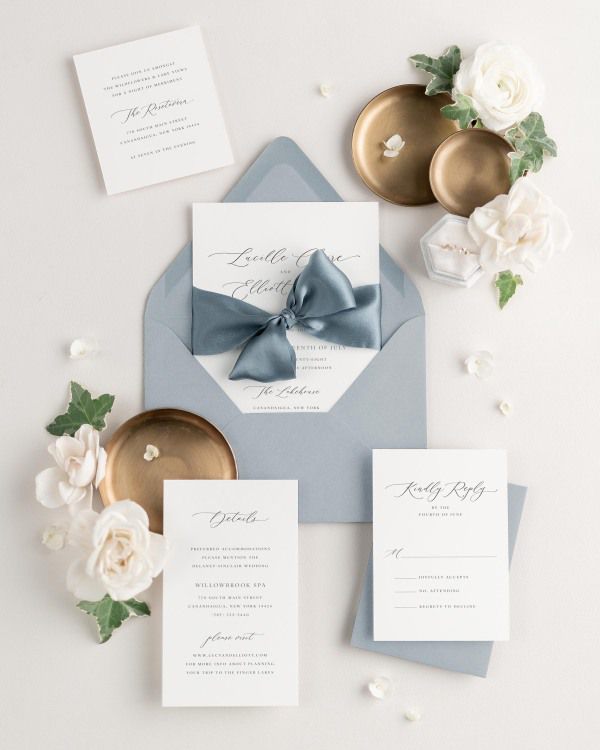 Lucille wedding invitations with glacier light blue envelopes, steel blue silk ribbon, and matching enclosure cards.