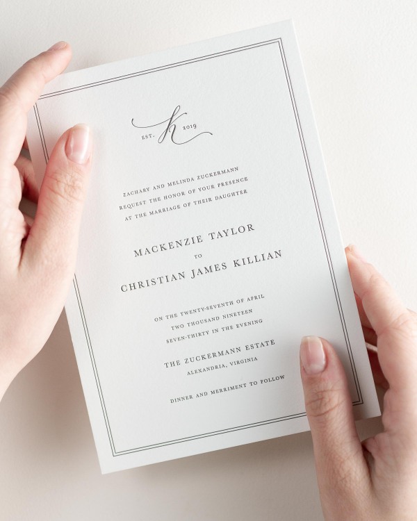 Bride holding her 5x7” Mackenzie letterpress wedding invitation.