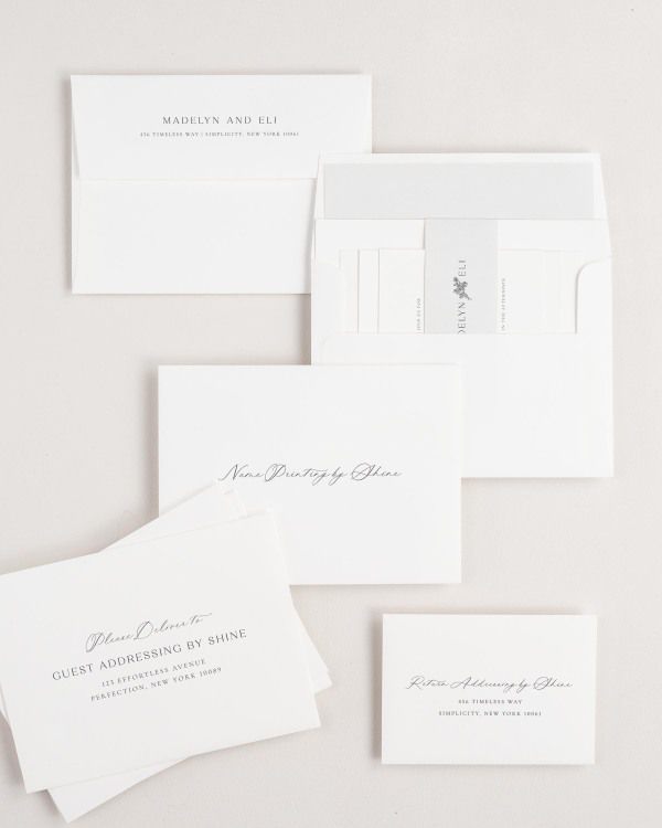 Madelyn wedding invitation envelopes with guest addressing, return addressing, and name printing services. Inner envelope features a solid liner and soft gray belly band.