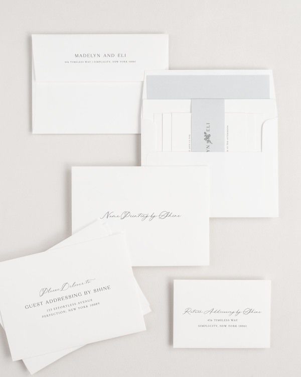 Madelyn wedding invitation envelopes with guest addressing, return addressing, and name printing services. Inner envelope features a solid liner and cloud belly band.