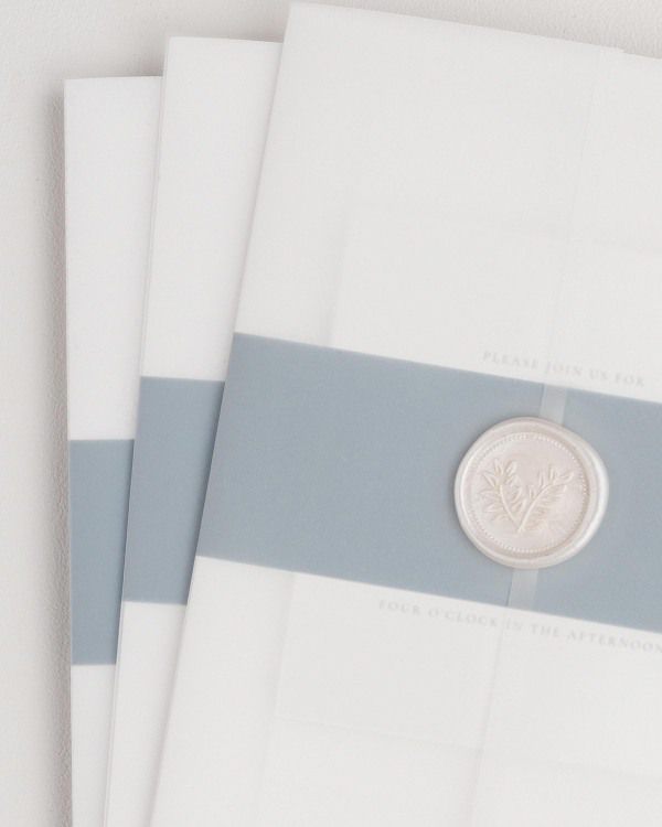 Madelyn wedding invitation with a mineral belly band, translucent vellum jacket, and pearl wreath wax seal.