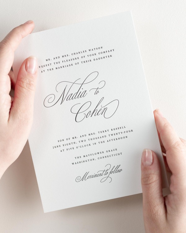 Bride holding her 5x7” Nadia letterpress wedding invitation.
