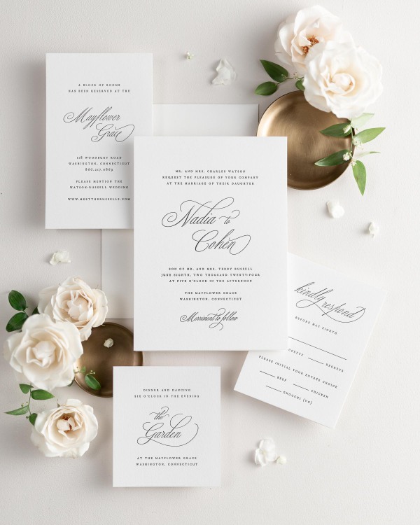 All pieces of the Nadia letterpress wedding invitation suite, including the invitation, small and large enclosures, and response card.