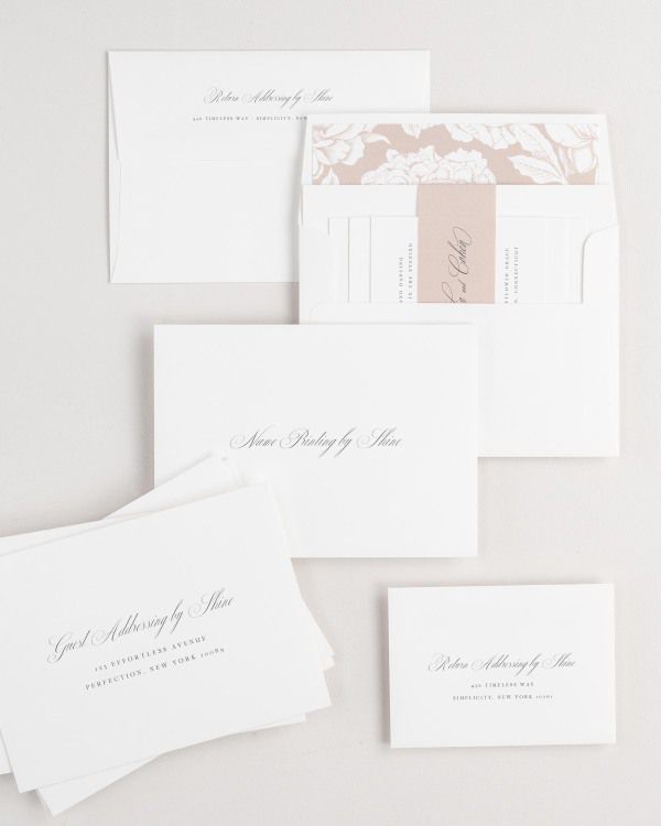 Nadia wedding invitation envelopes with guest addressing, return addressing, and name printing services. Inner envelope features a blooms liner and rosewater belly band.