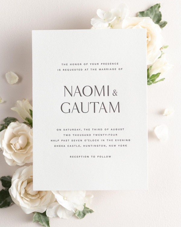 Naomi letterpress wedding invitation styled with pretty florals.