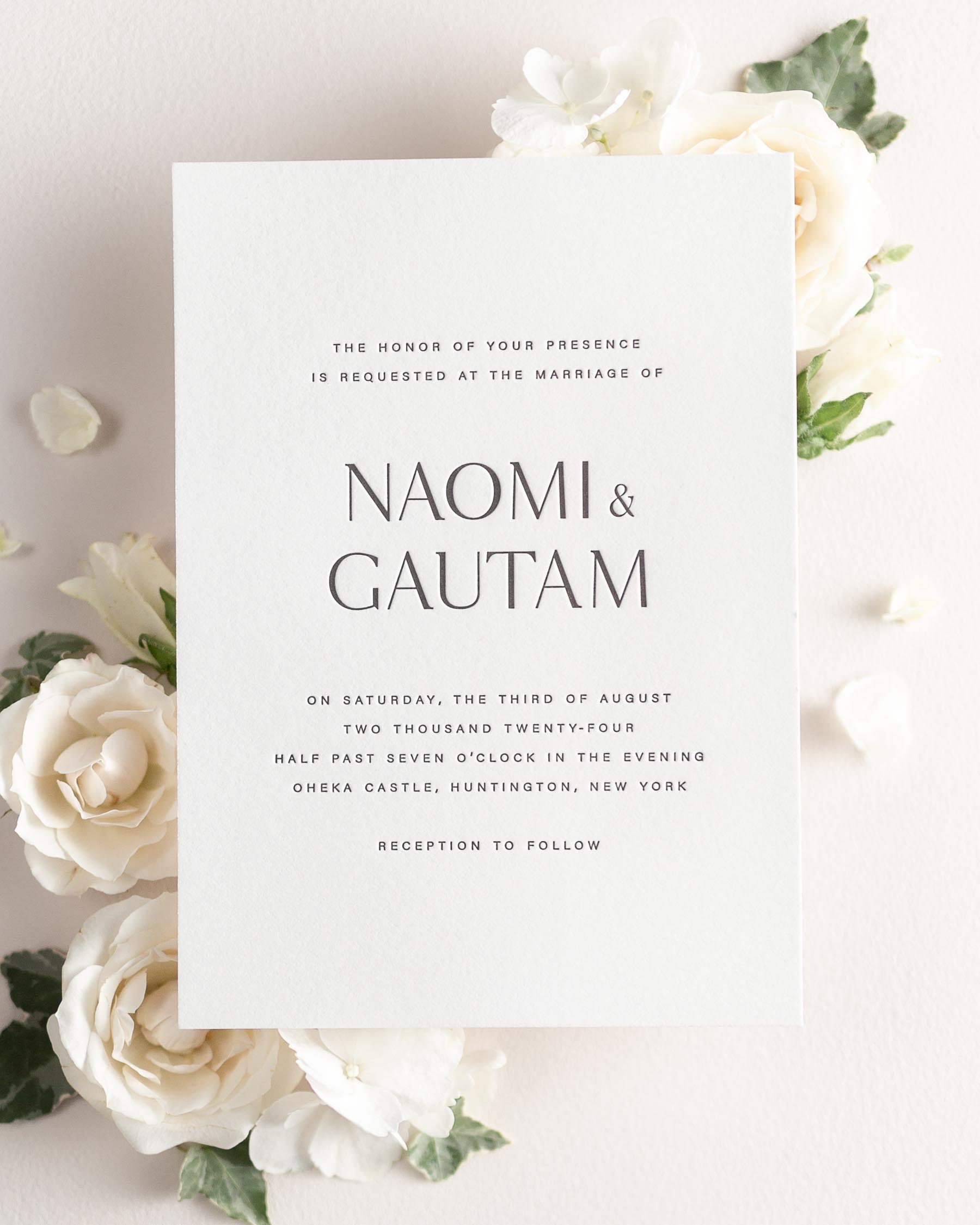Naomi letterpress wedding invitation styled with pretty florals.