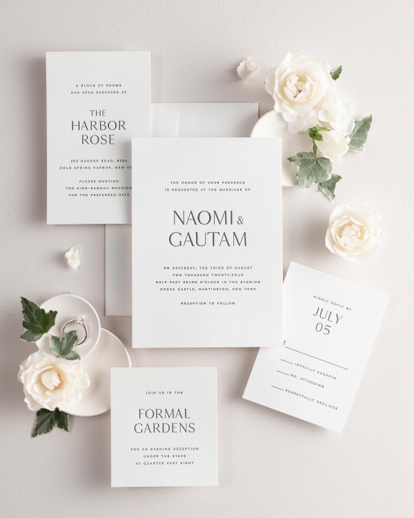 All pieces of the Naomi letterpress wedding invitation suite, including the invitation, small and large enclosures, and response card.