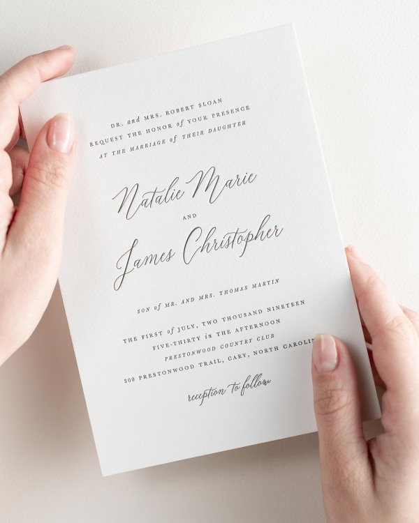 Bride holding her 5x7” Natalie letterpress wedding invitation.