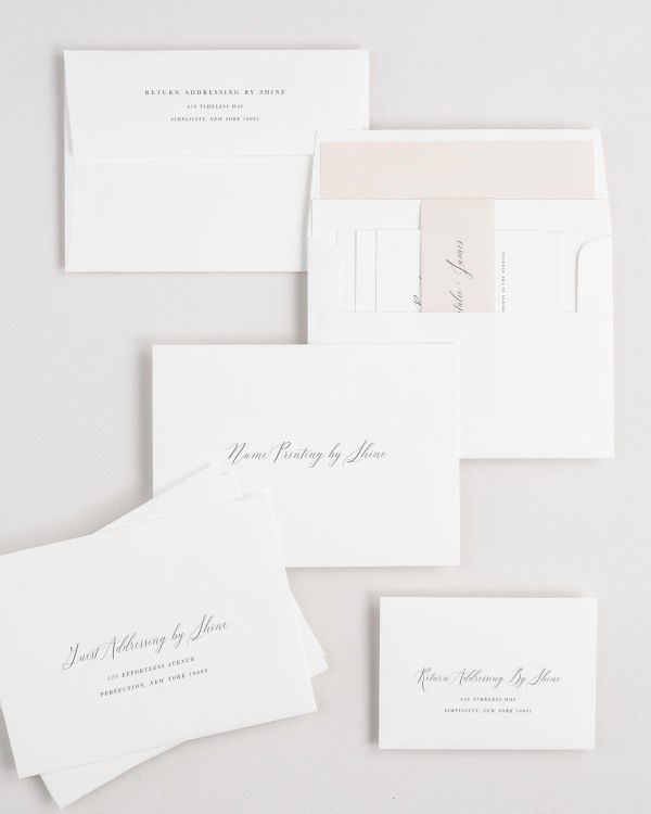 Natalie wedding invitation envelopes with guest addressing, return addressing, and name printing services. Inner envelope features a solid liner and rose gold belly band.