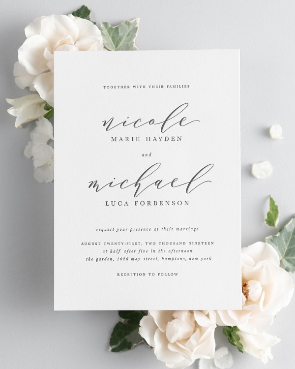 Nicole letterpress wedding invitation styled with pretty florals.