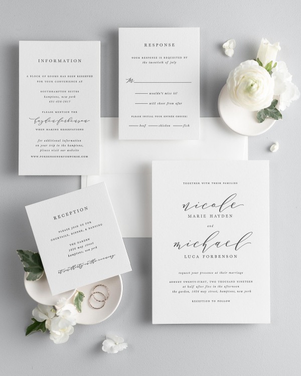 All pieces of the Nicole letterpress wedding invitation suite, including the invitation, small and large enclosures, and response card.