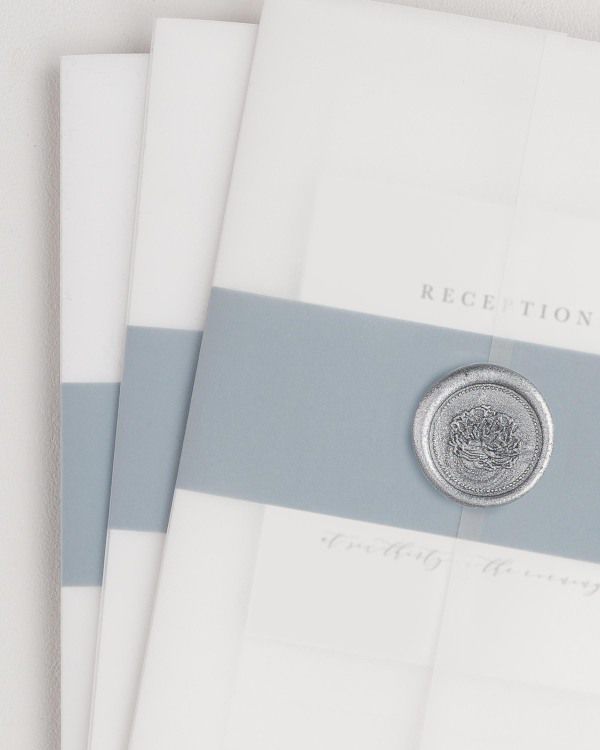 Nicole wedding invitation with a mineral belly band, translucent vellum jacket, and silver florette wax seal.