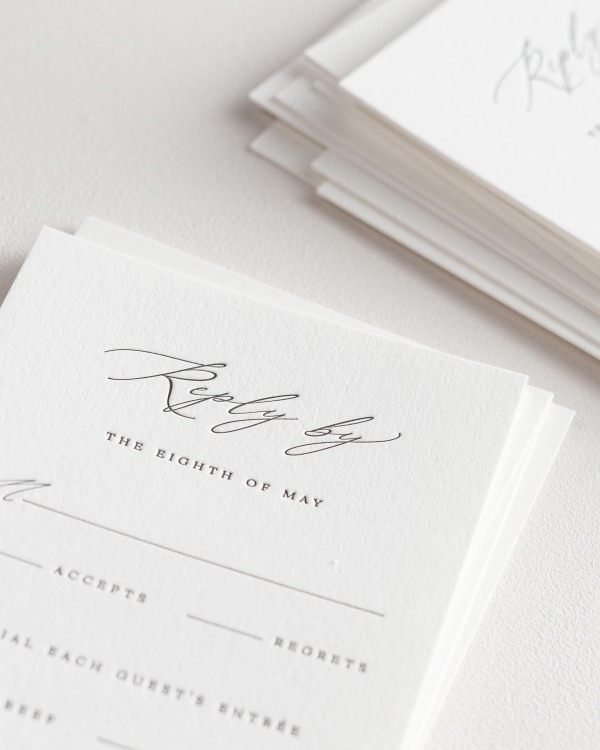 Dreamy close up shot of Noelle response cards. Deep impressions in the paper are a result of the letterpress printing process.