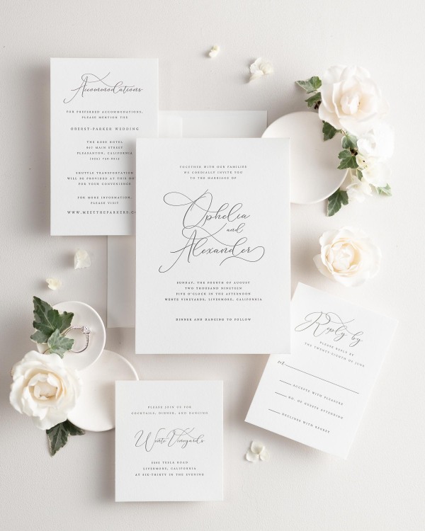 All pieces of the Ophelia letterpress wedding invitation suite, including the invitation, small and large enclosures, and response card.