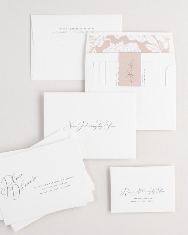 Ophelia wedding invitation envelopes with guest addressing, return addressing, and name printing services. Inner envelope features a blooms liner and rosewater belly band.