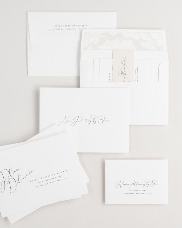 Ophelia wedding invitation envelopes with guest addressing, return addressing, and name printing services. Inner envelope features a blooms liner and nude belly band.
