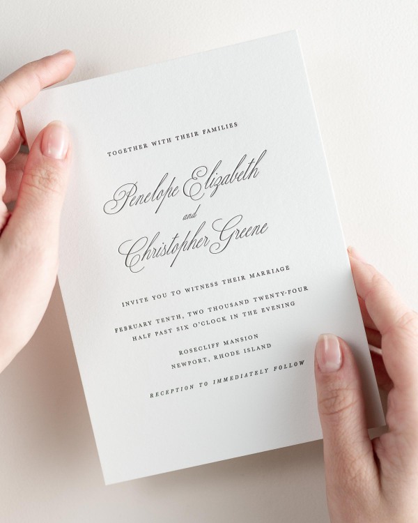 Bride holding her 5x7” Penelope letterpress wedding invitation.