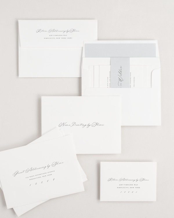 Phoebe wedding invitation envelopes with guest addressing, return addressing, and name printing services. Inner envelope features a liner and cloud belly band.