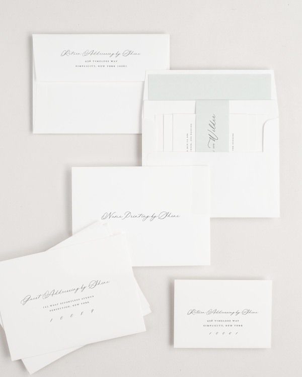 Phoebe wedding invitation envelopes with guest addressing, return addressing, and name printing services. Inner envelope features a solid liner and sea salt belly band.