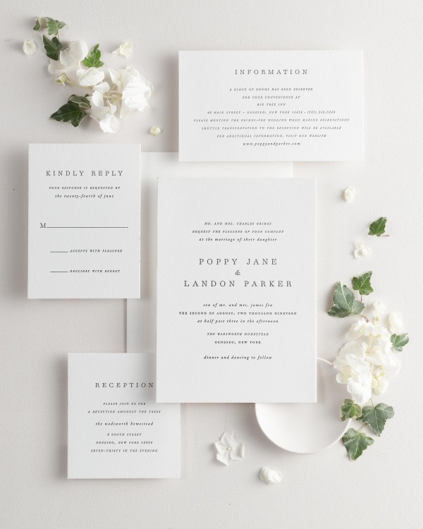 All pieces of the Poppy letterpress wedding invitation suite, including the invitation, small and large enclosures, and response card.