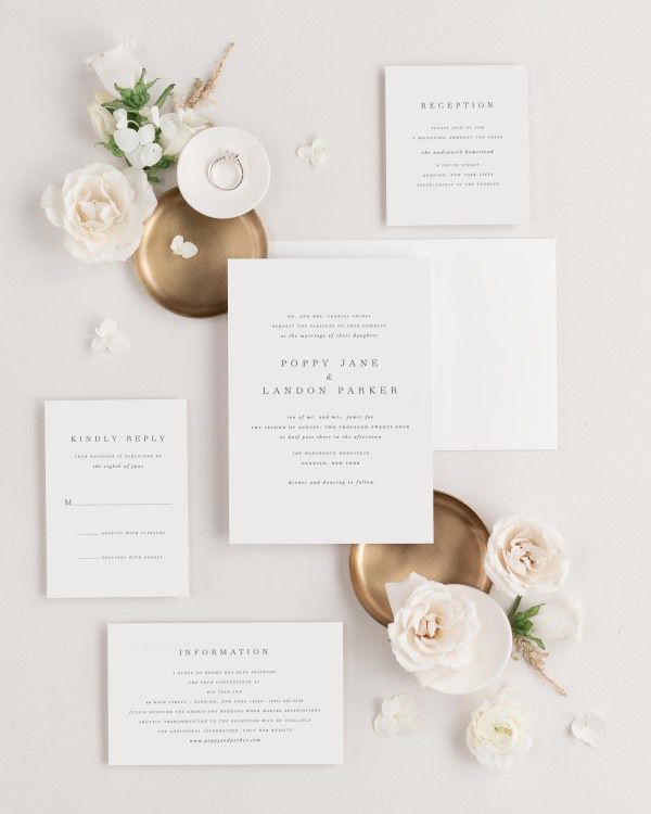 Poppy wedding invitations flat lay with