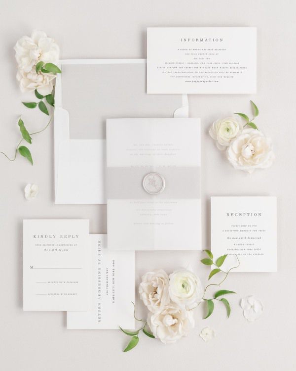 Poppy wedding invitations flat lay with stone solid liner, stone belly band, translucent vellum jacket, and pearl posy wax seal.