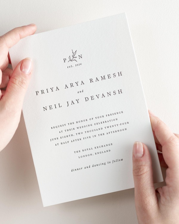 Bride holding her 5x7” Priya letterpress wedding invitation.