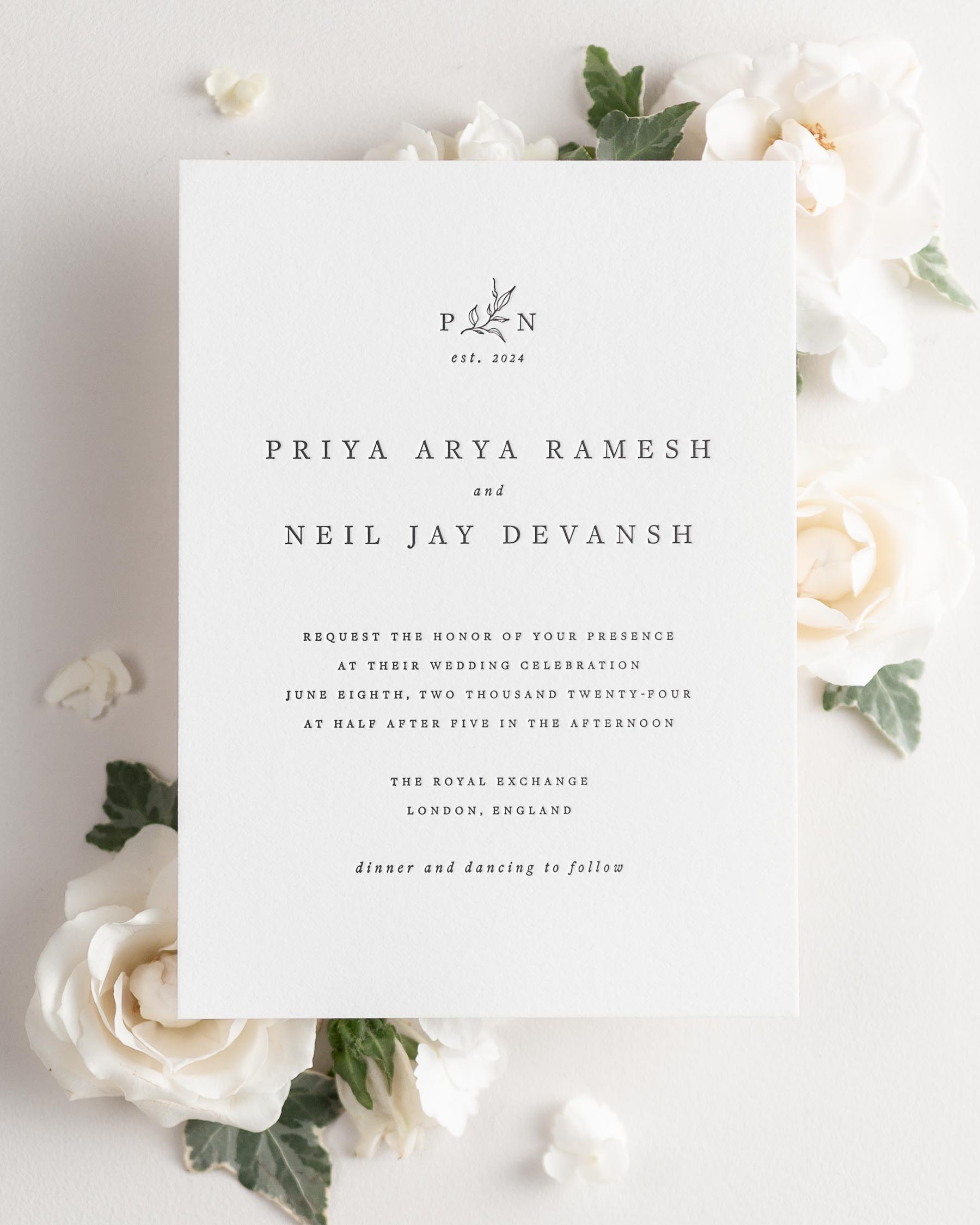 Priya letterpress wedding invitation styled with pretty florals.