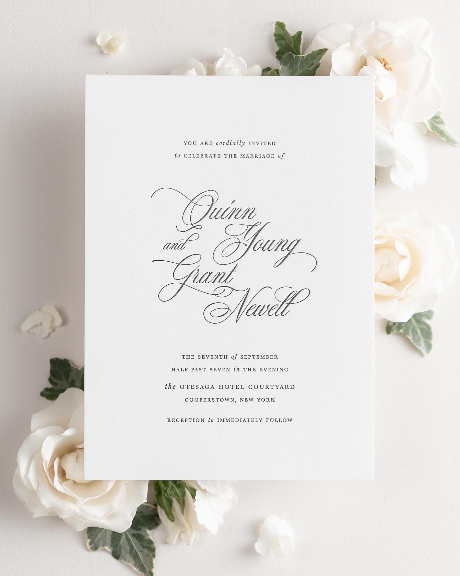 Quinn letterpress wedding invitation styled with pretty florals.