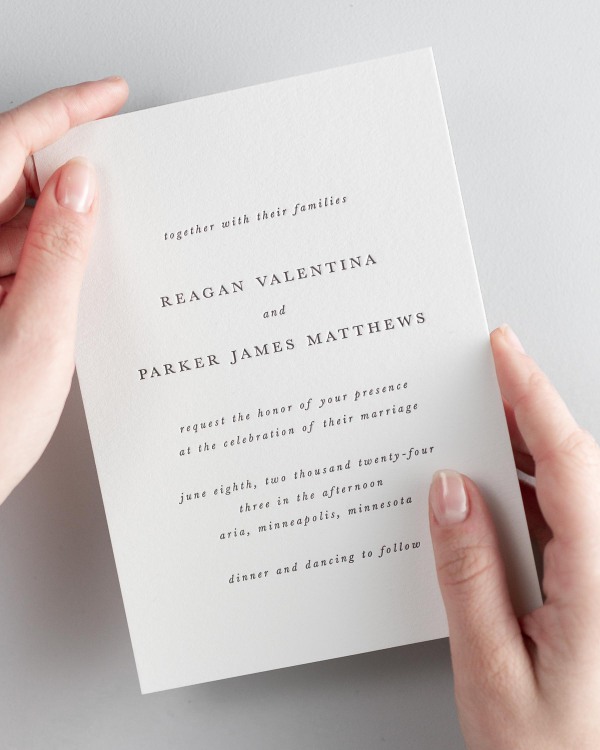 Bride holding her 5x7” Reagan letterpress wedding invitation.