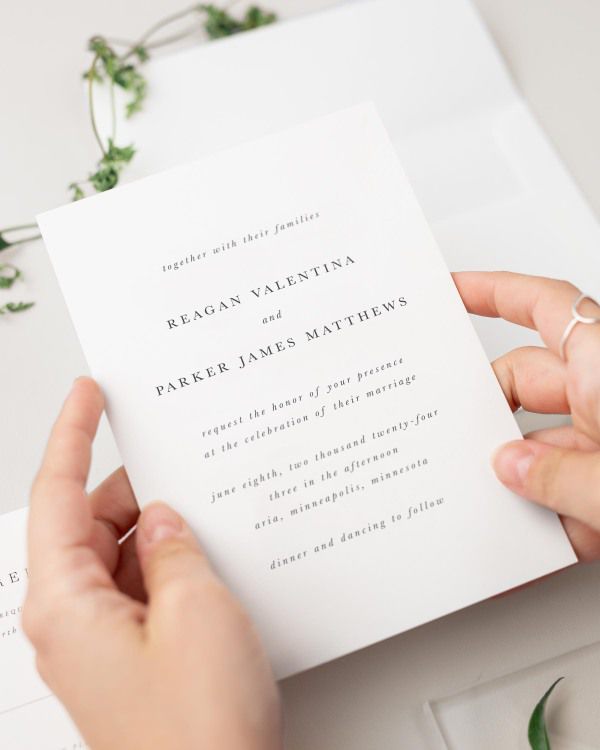 Bride holding her Reagan wedding invitation.