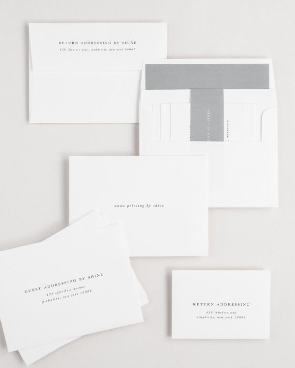 Reagan wedding invitation envelopes with guest addressing, return addressing, and name printing services. Inner envelope features a solid liner and slate belly band.