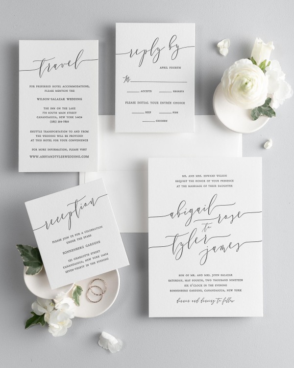 All pieces of the Romantic Calligraphy letterpress wedding invitation suite, including the invitation, small and large enclosures, and response card.
