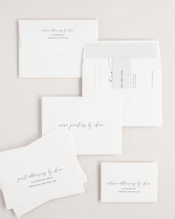 Romantic Calligraphy wedding invitation envelopes with guest addressing, return addressing, and name printing services. Inner envelope features a solid liner and soft gray belly band.