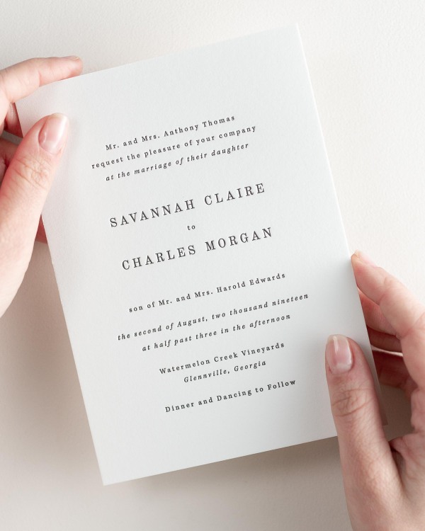 Bride holding her 5x7” Savannah letterpress wedding invitation.