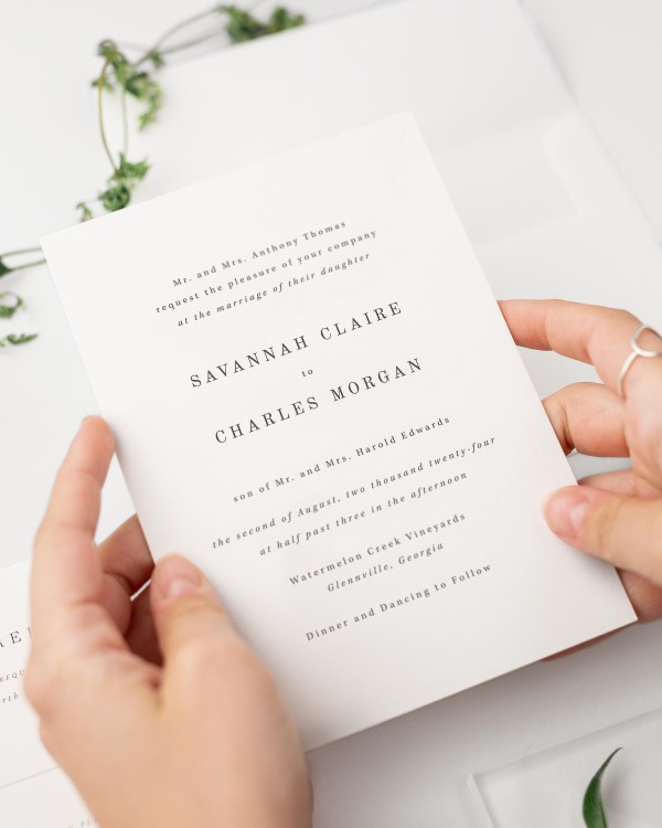 Bride holding her Savannah wedding invitation.