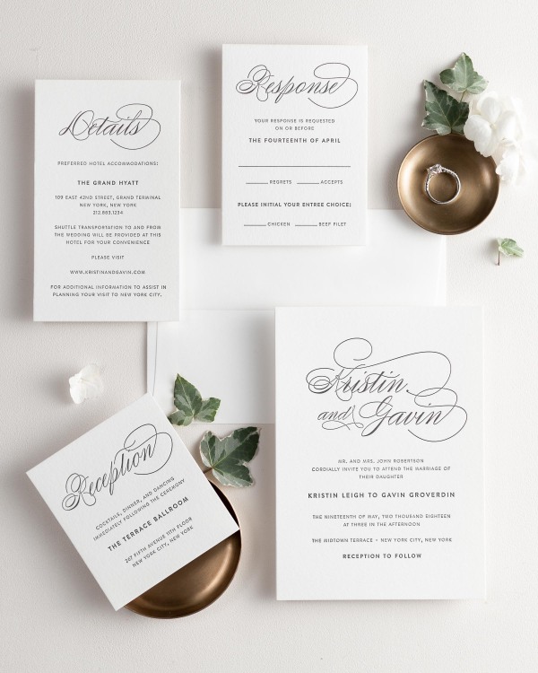All pieces of the Script Elegance letterpress wedding invitation suite, including the invitation, small and large enclosures, and response card.