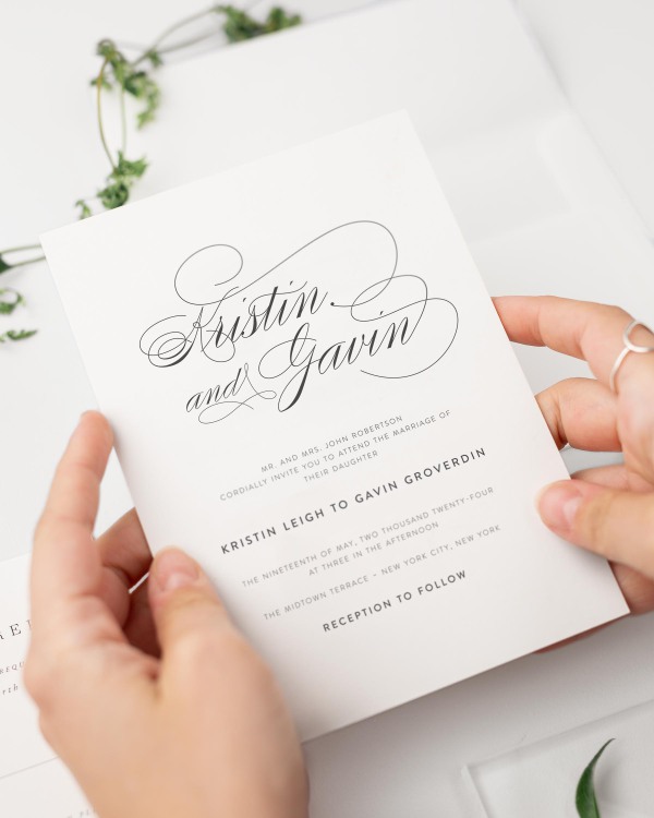 Bride holding her Script Elegance wedding invitation.