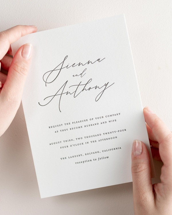 Bride holding her 5x7” Sienna letterpress wedding invitation.
