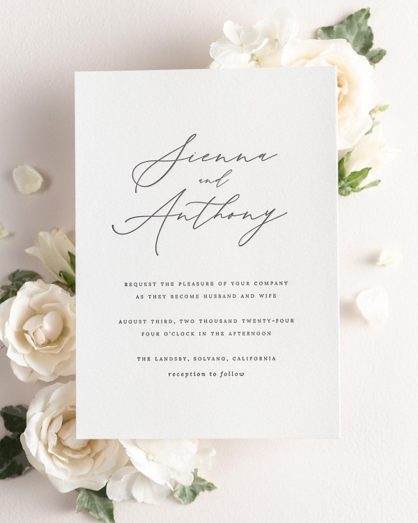 Sienna letterpress wedding invitation styled with pretty florals.