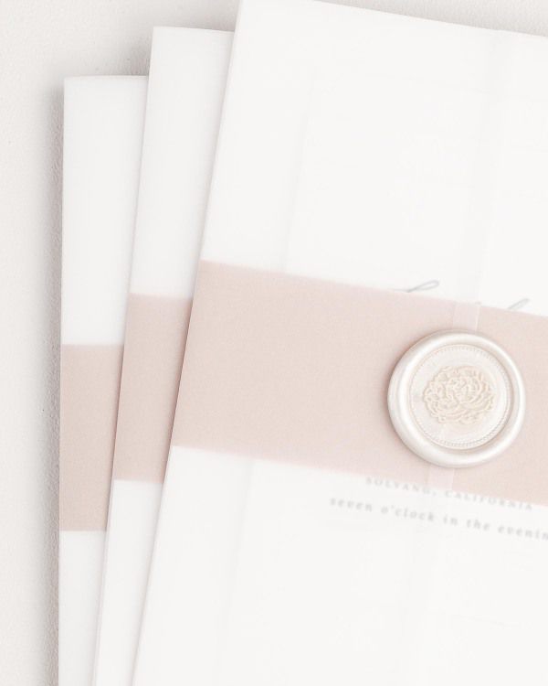Sienna wedding invitation with a rosewater belly band, translucent vellum jacket, and pearl florette wax seal.