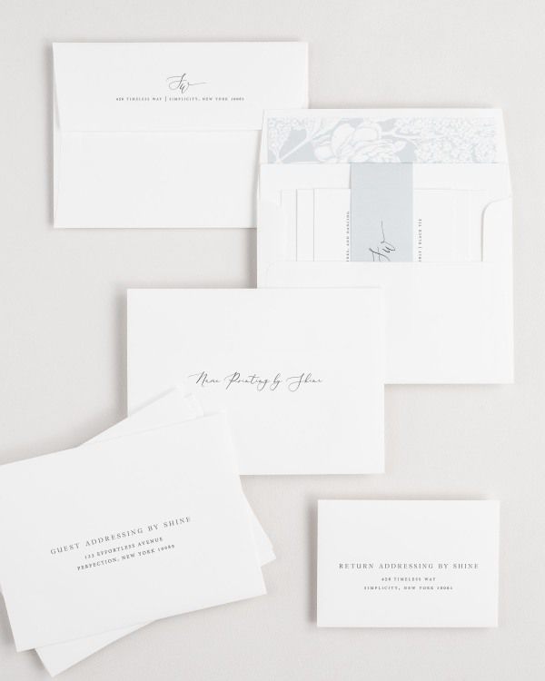 Sloan wedding invitation envelopes with guest addressing, return addressing, and name printing services. Inner envelope features a hydrangea liner and cloud belly band.