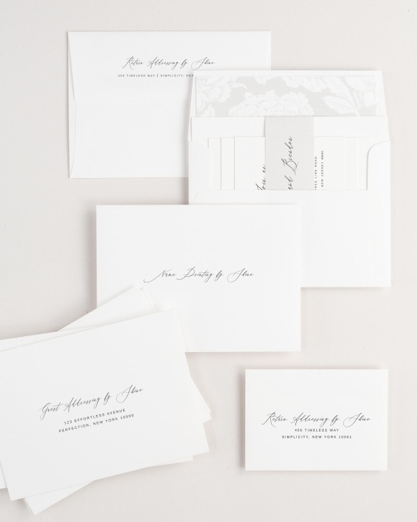 Sophia wedding invitation envelopes with guest addressing, return addressing, and name printing services. Inner envelope features a blooms liner and soft gray belly band.