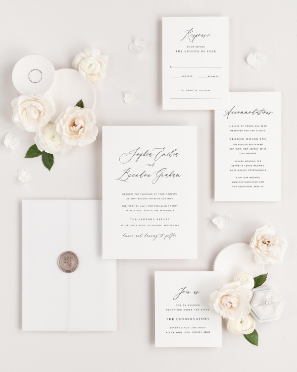 Sophia wedding invitations flat lay with translucent vellum jacket, and bronze posy wax seal.