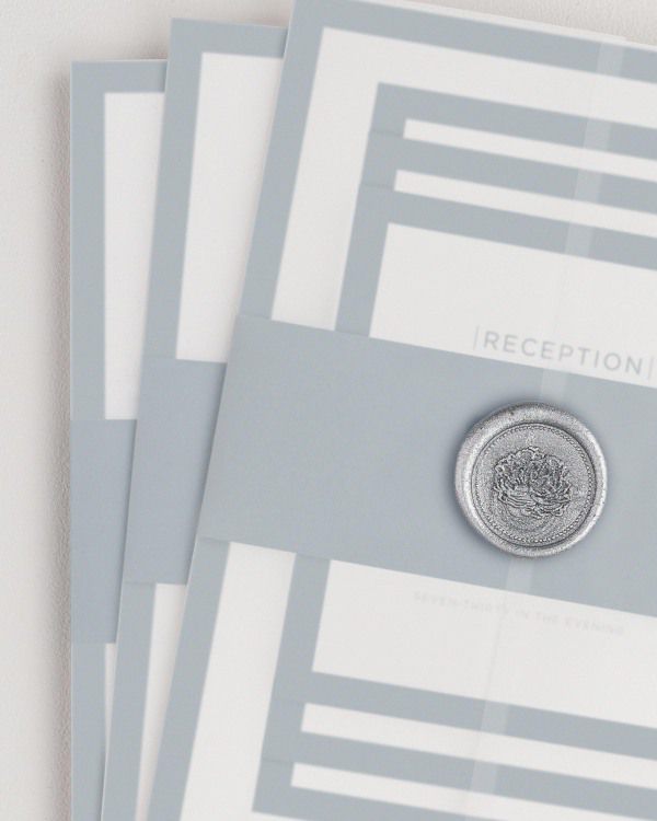 Sophisticated Modern wedding invitation with a mineral belly band, translucent vellum jacket, and silver florette wax seal.