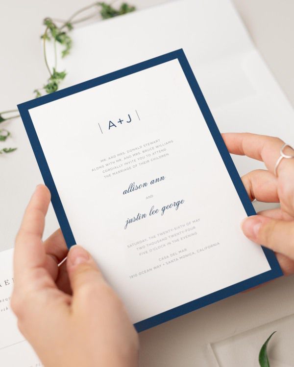 Bride holding her Sophisticated Modern wedding invitation.