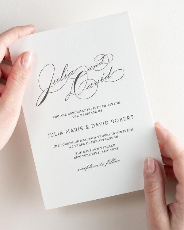 Bride holding her 5x7” Vintage Glam letterpress wedding invitation.