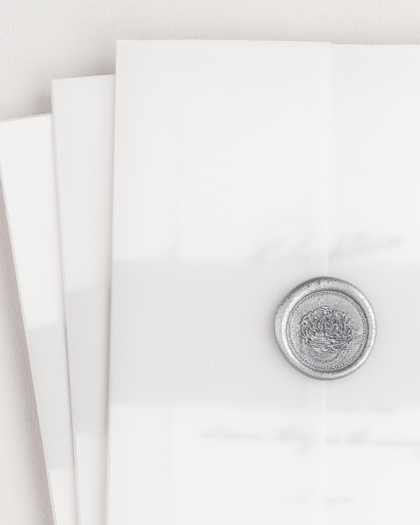 Vintage Glam wedding invitation with a belly band, translucent vellum jacket, and silver florette wax seal.
