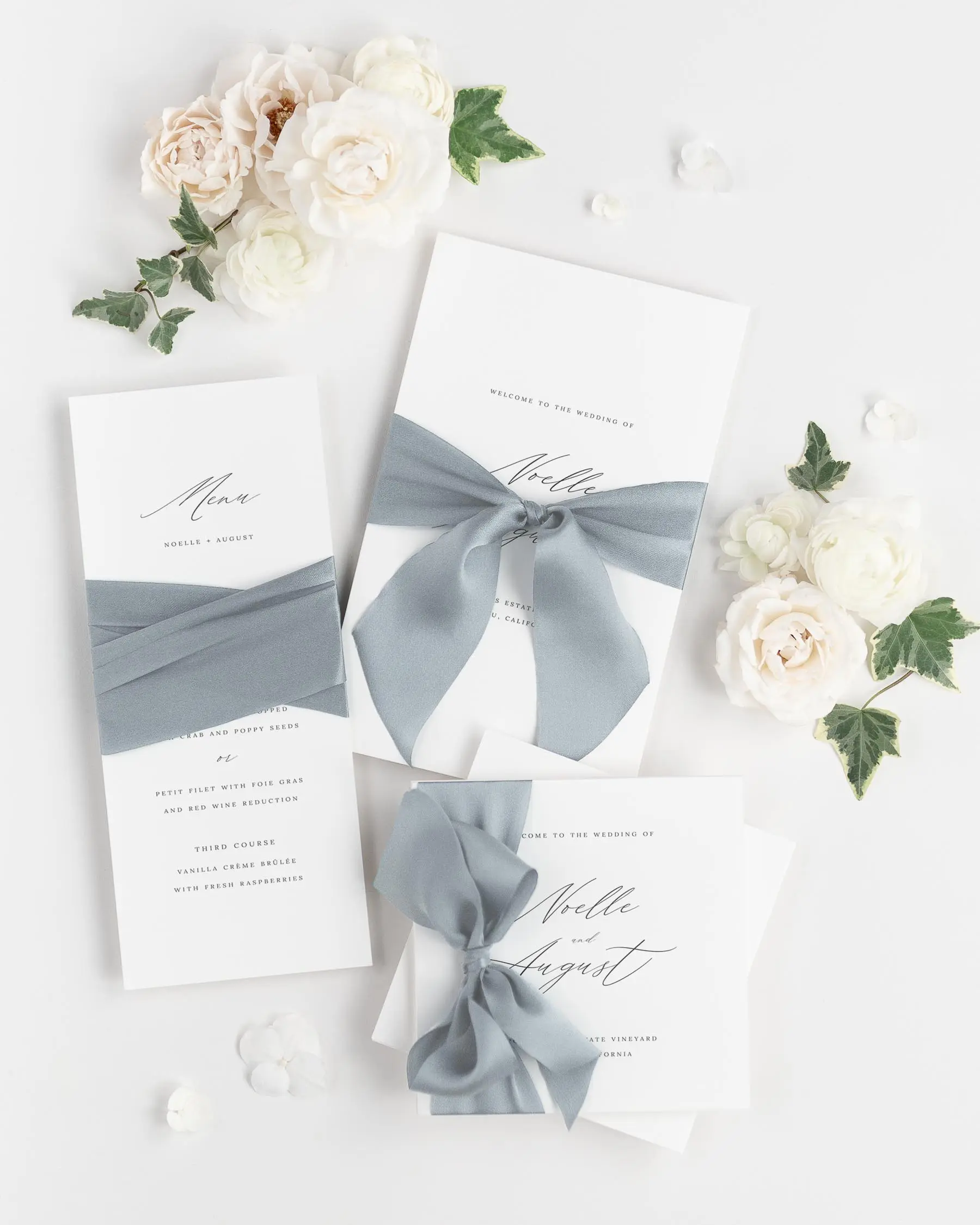 Light Blue Gray Ribbon Tied Around Wedding Programs