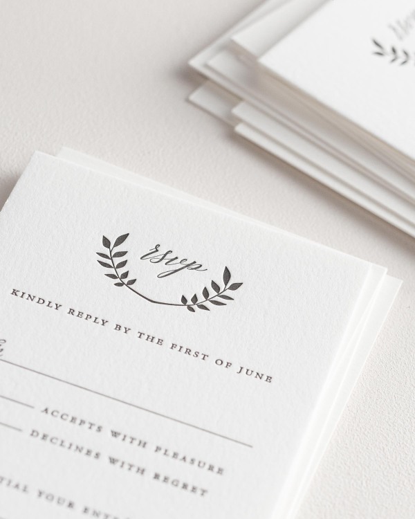 Dreamy close up shot of Wreath Monogram response cards. Deep impressions in the paper are a result of the letterpress printing process.